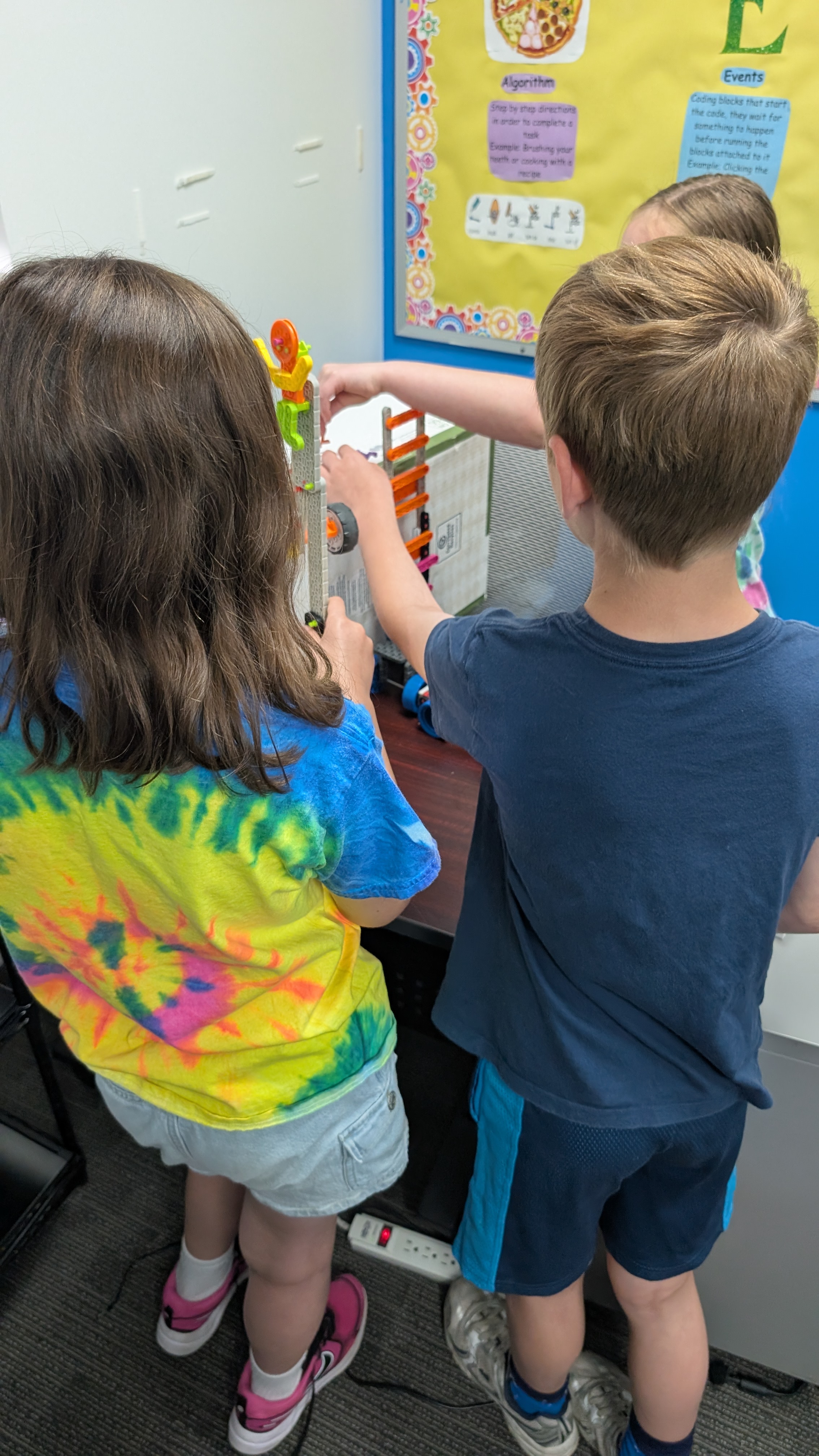 Students work together on a LEGO robotics build during a classroom design challenge.